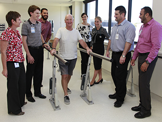 St Stephen's Rehabilitation Services St Stephen's rehabilitation team watch as Dale Barwise-Smith tries out the new gym equipment.