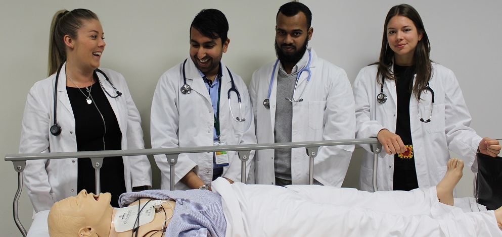 clinical School student group clinical School student group inspecting teaching mannequin