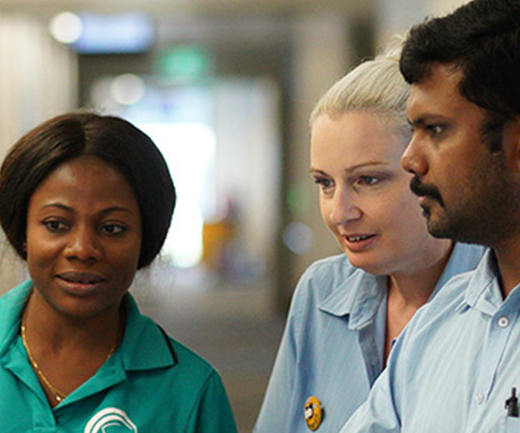 Three young graduate nurses gather around a digital screen at St Stephen's Hospital, Hervey Bay.